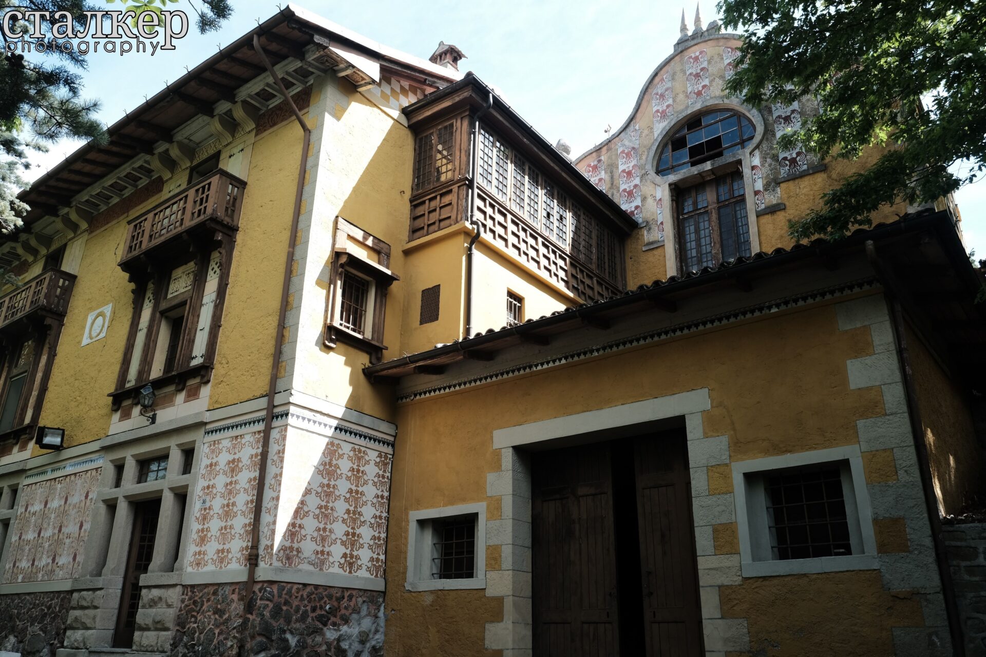 Eclectic exterior facade with Art Nouveau influences surrounded by trees — Bolognese Apennines