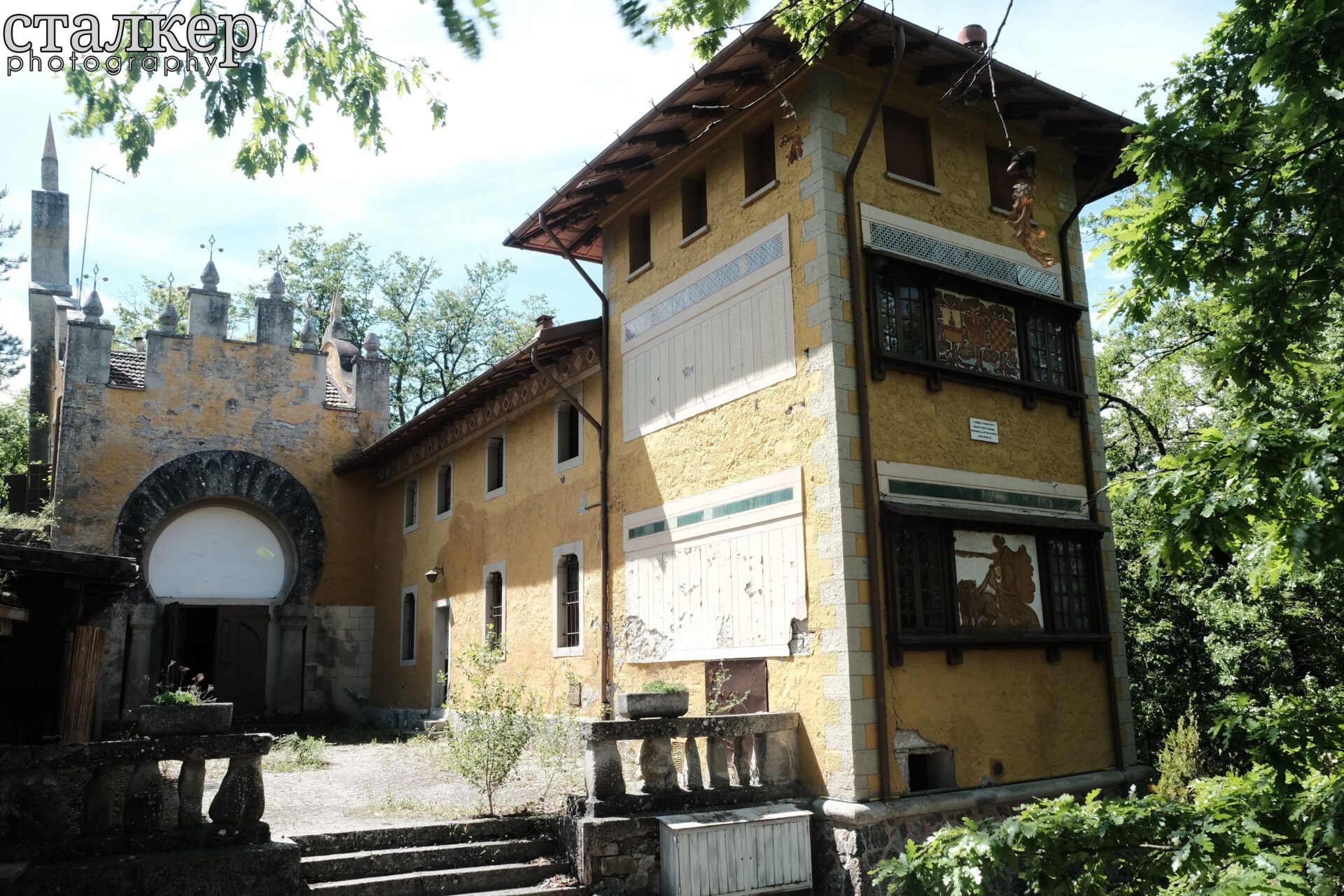 Eclectic exterior facade with Art Nouveau influences surrounded by trees — Bolognese Apennines