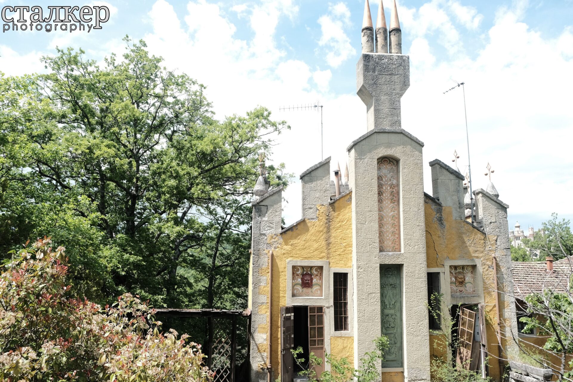 Eclectic exterior facade with Art Nouveau influences surrounded by trees — Bolognese Apennines