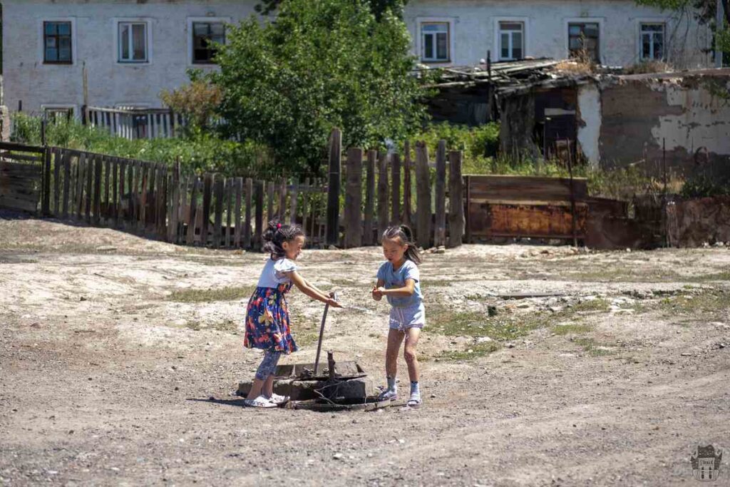 Girls playing in the abandoned village of Ming-Kush